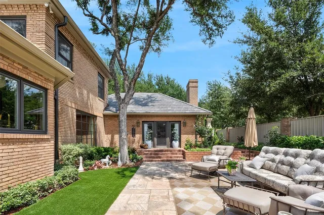 a view of house with outdoor seating and green space