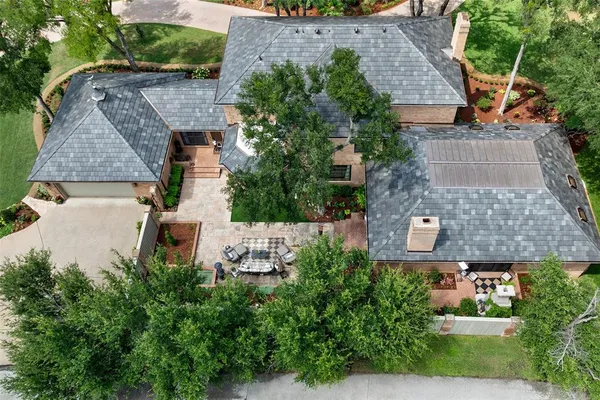 an aerial view of a house with balcony and garden