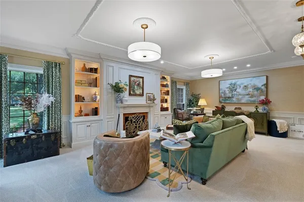 a living room with furniture a fireplace and a large window