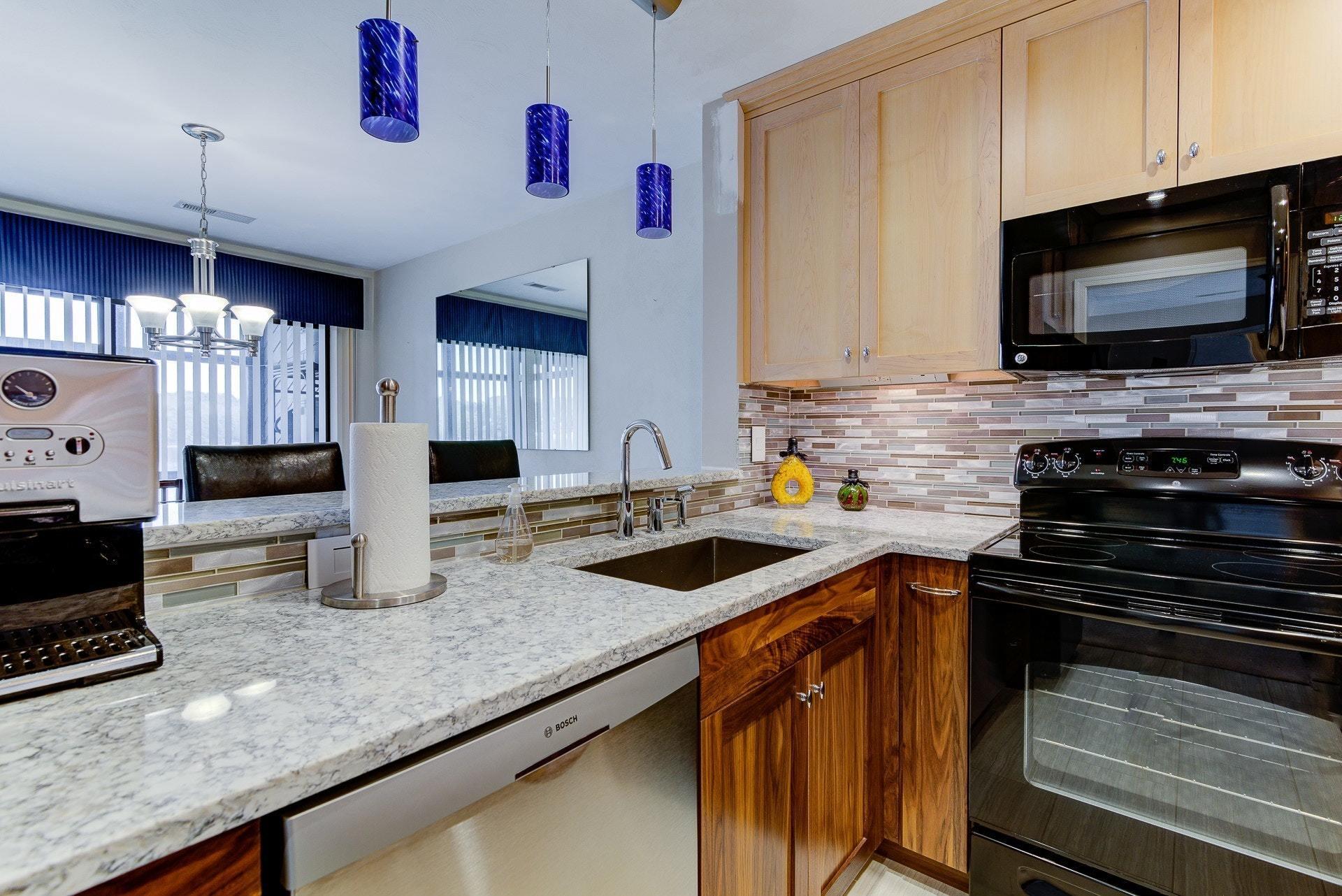 835 Gangplank Road, Unit 103 Moneta, VA 24121 - Photo 14 of 34 a kitchen with granite countertop a sink stainless steel appliances and counter space