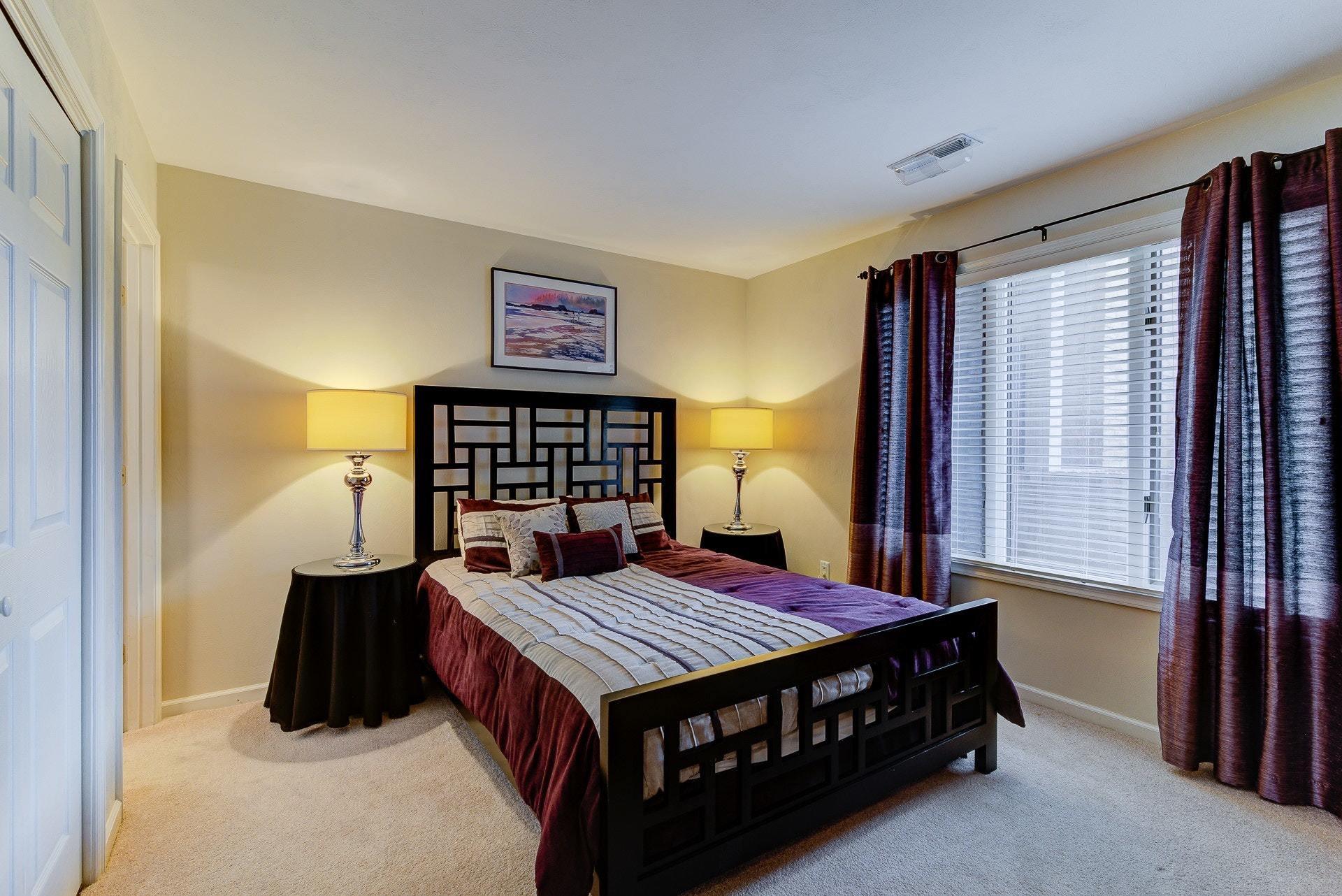 835 Gangplank Road, Unit 103 Moneta, VA 24121 - Photo 21 of 34 a bedroom with a bed and wooden floor