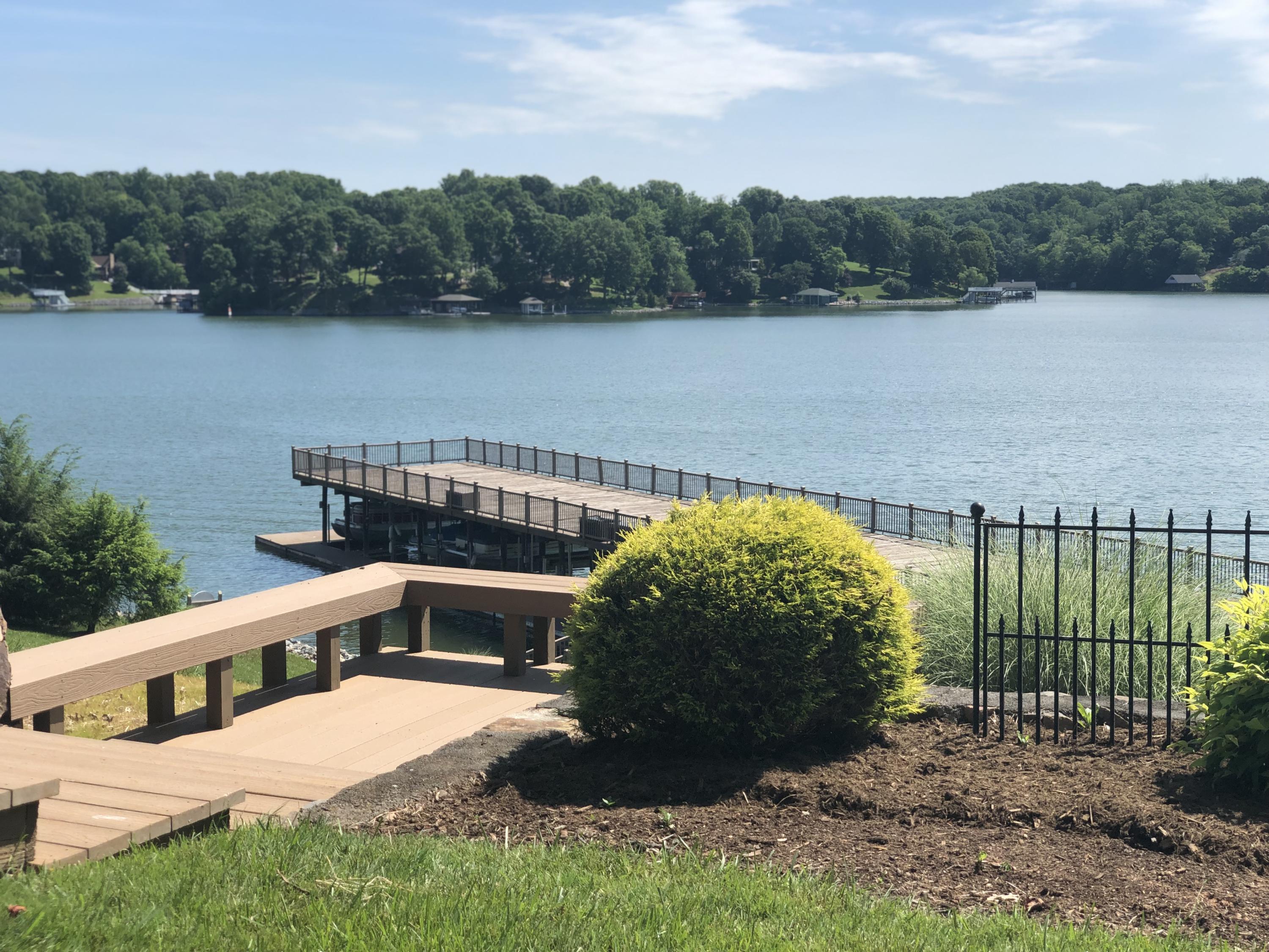 835 Gangplank Road, Unit 103 Moneta, VA 24121 - Photo 29 of 34 a view of a lake with a yard and large trees