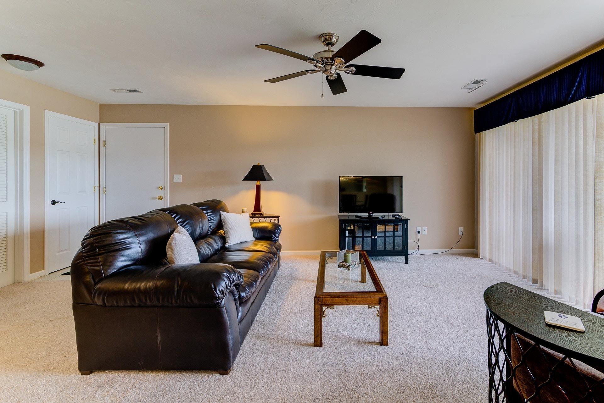835 Gangplank Road, Unit 103 Moneta, VA 24121 - Photo 8 of 34 a living room with furniture and a flat screen tv