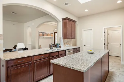 a bathroom with a granite countertop sink a mirror and a vanity