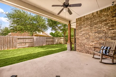 a view of a porch with a table and chairs
