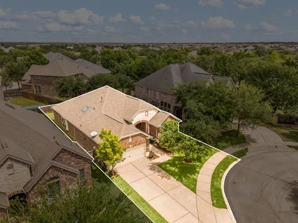 an aerial view of a house with a yard and lake view