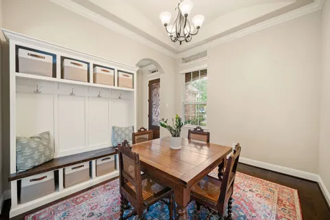 a view of a dining room with furniture and chandelier