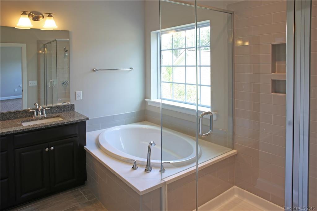 140 Helton Lane, Unit 36 Fort Mill, SC 29708 - Photo 14 of 21 a bathroom with a tub sink and mirror