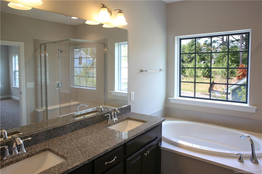 140 Helton Lane, Unit 36 Fort Mill, SC 29708 - Photo 16 of 21 a bathroom with a granite countertop sink and a bathtub