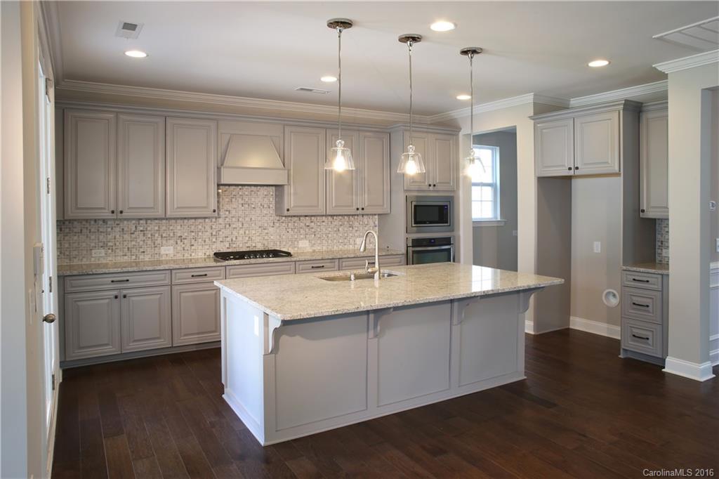 140 Helton Lane, Unit 36 Fort Mill, SC 29708 - Photo 20 of 21 a large kitchen with cabinets a sink dishwasher a refrigerator and a stove with wooden floor