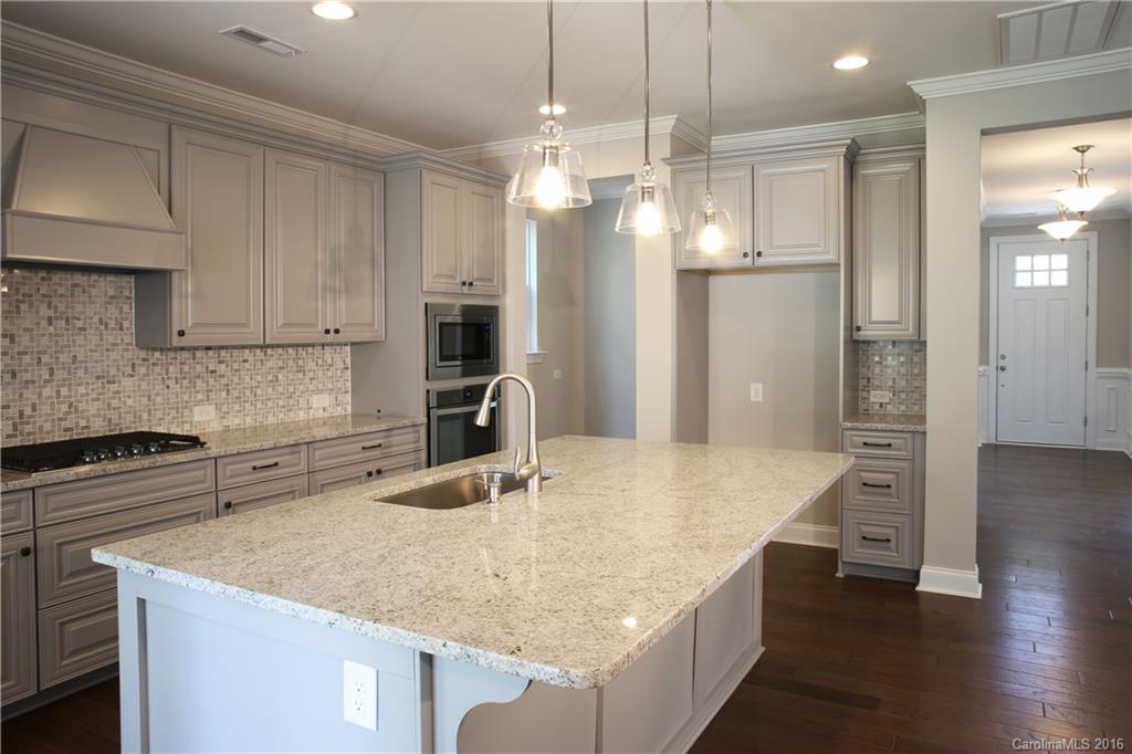 140 Helton Lane, Unit 36 Fort Mill, SC 29708 - Photo 3 of 21 a kitchen with stainless steel appliances granite countertop a sink refrigerator and cabinets