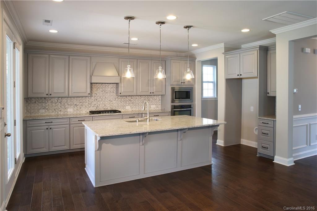 140 Helton Lane, Unit 36 Fort Mill, SC 29708 - Photo 21 of 21 a large kitchen with cabinets wooden floor and stainless steel appliances