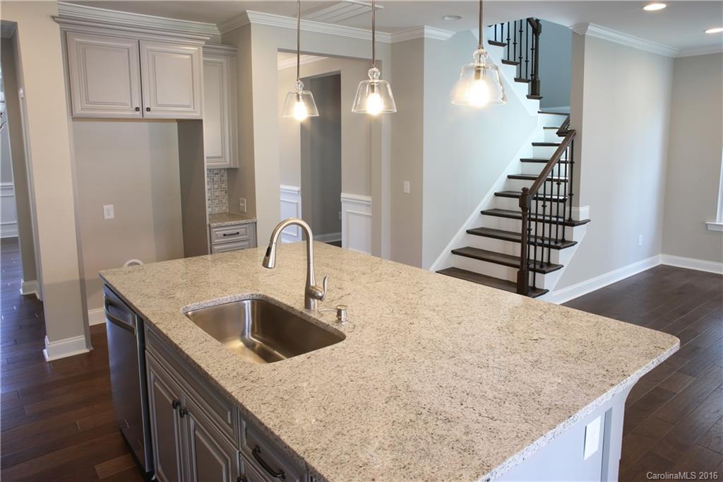 140 Helton Lane, Unit 36 Fort Mill, SC 29708 - Photo 5 of 21 a kitchen with kitchen island a sink and a stove