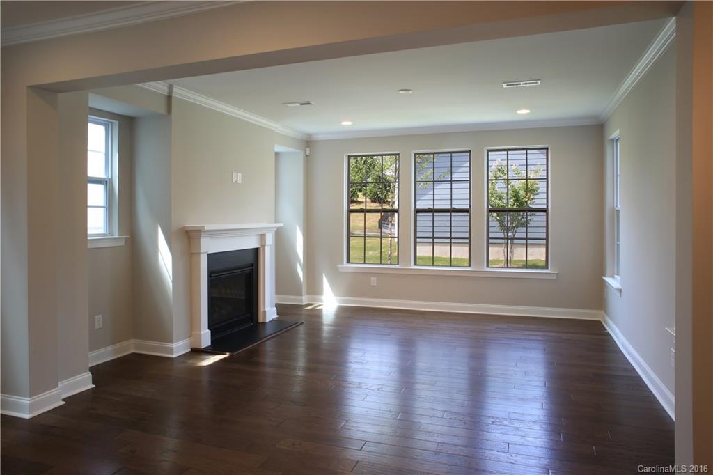 140 Helton Lane, Unit 36 Fort Mill, SC 29708 - Photo 6 of 21 a view of an empty room with wooden floor and a window