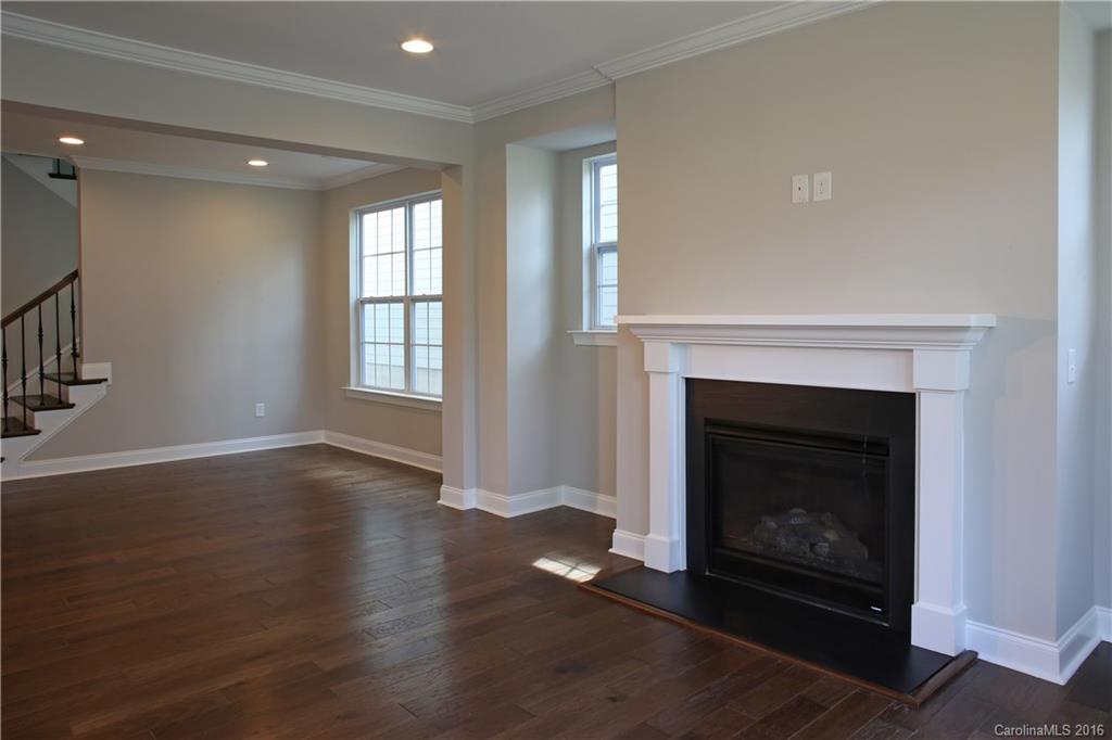 140 Helton Lane, Unit 36 Fort Mill, SC 29708 - Photo 7 of 21 a view of an empty room with wooden floor fireplace and a window
