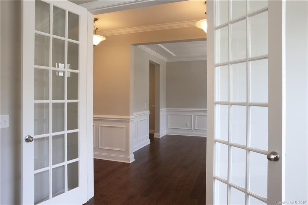 140 Helton Lane, Unit 36 Fort Mill, SC 29708 - Photo 8 of 21 a view of an empty room with wooden floor and cabinet