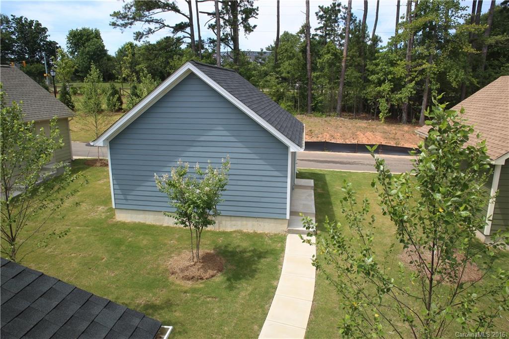 140 Helton Lane, Unit 36 Fort Mill, SC 29708 - Photo 10 of 21 a backyard of a house with table and chairs plants