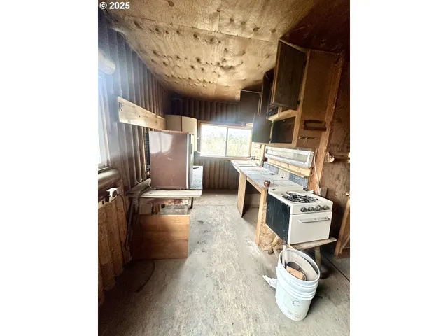 a kitchen with refrigerator and window