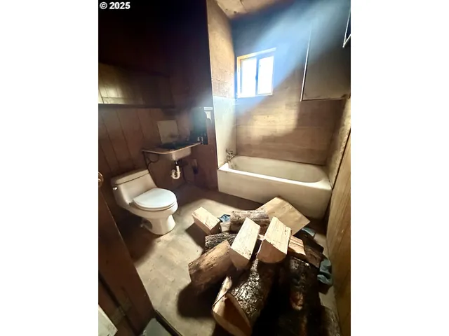 a bathroom with a toilet and a tub