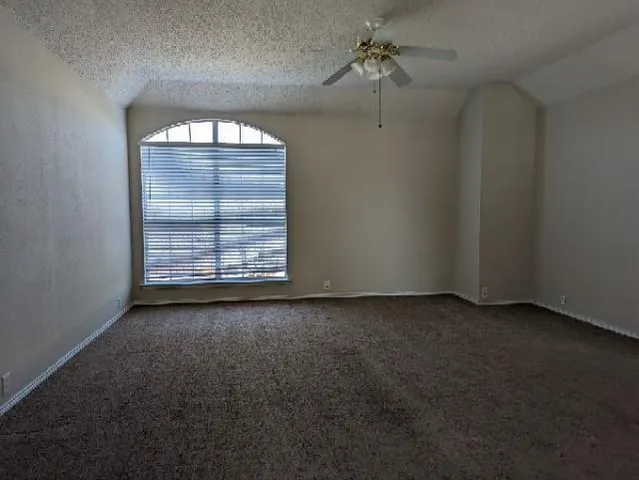 an empty room with a empty space and windows