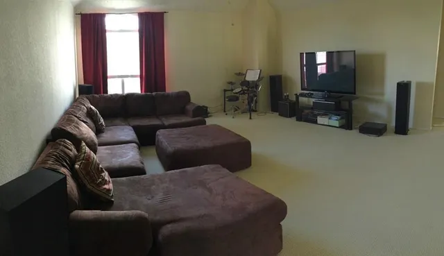 a living room with furniture and a flat screen tv