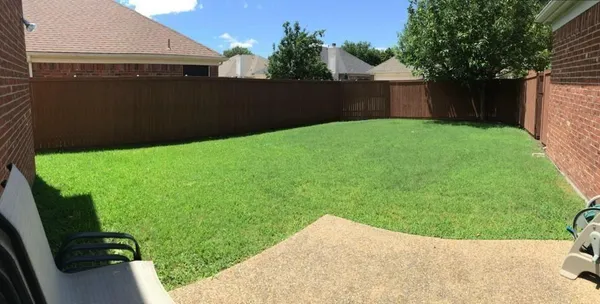 a backyard of a house with lots of green space