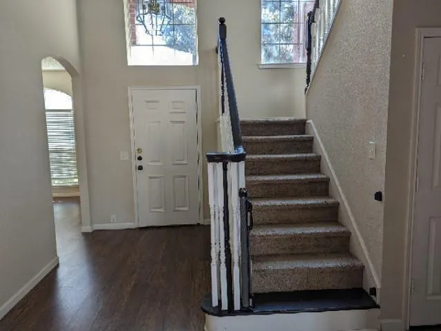 a view of entryway with wooden floor and stairs