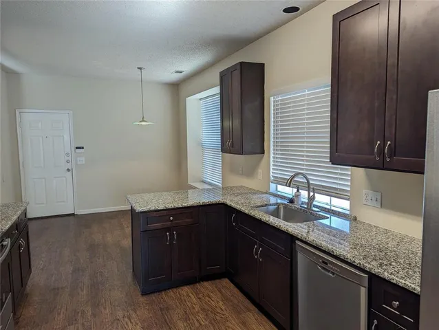 a kitchen with a sink and wooden cabinets
