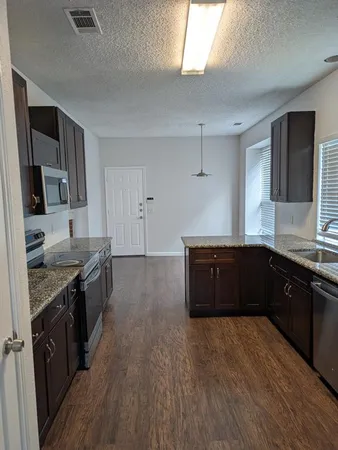 a kitchen with a sink and wooden cabinets