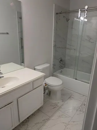 a bathroom with a toilet sink and shower