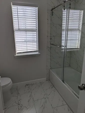 a bathroom with a shower and a toilet