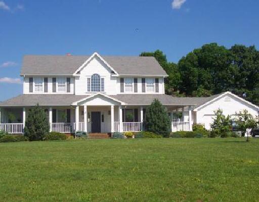 1640 Mill Iron Road Goodview, VA 24095 - Photo 1 of 1 a front view of a house with a garden and trees