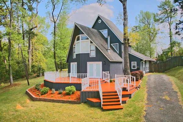 a front view of a house with a yard table and chairs