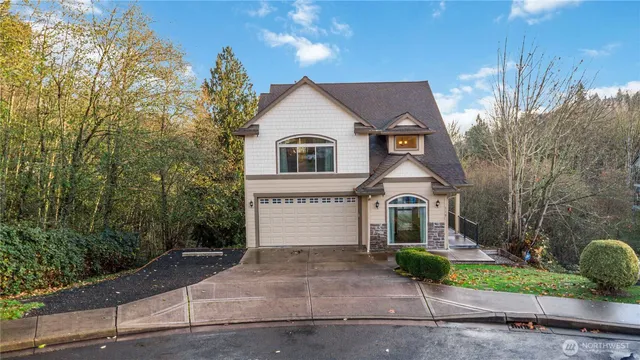 a front view of a house with a yard and garage