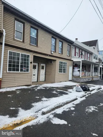 a front view of a house with a road
