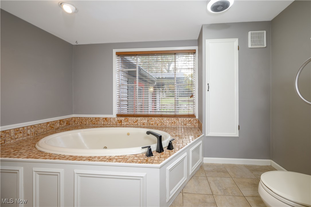 208 East Comet Road Clinton, OH 44216 - Photo 37 of 45 Bathroom with tile patterned floors, and a bathtub/jacuzzi brand