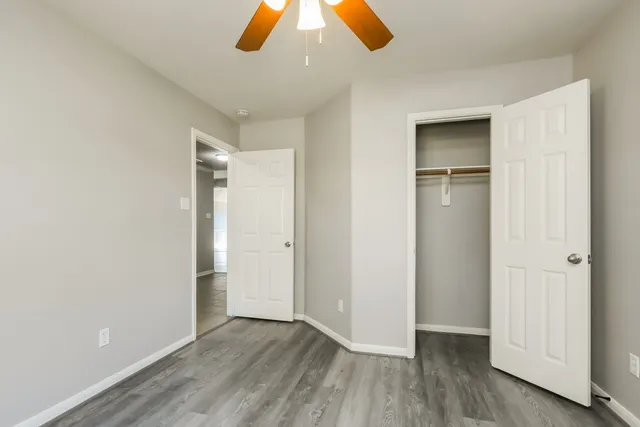an empty room with wooden floor and closet