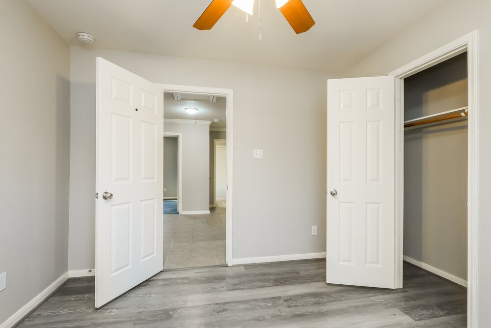 11747 Elizabeth Court Pinehurst, TX 77362 - Photo 14 of 16 an empty room with wooden floor and closet