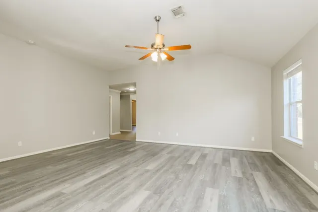 wooden floor in an empty room with a window