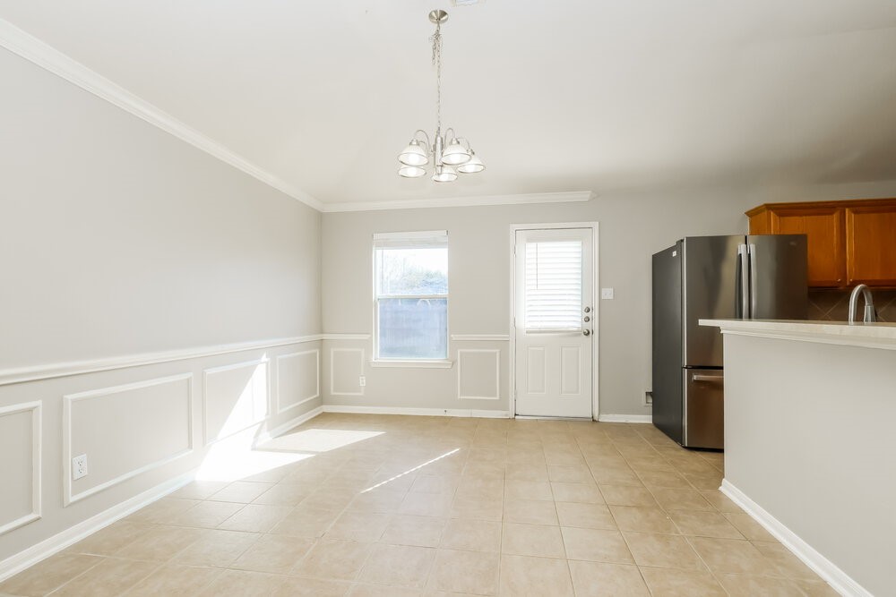 11747 Elizabeth Court Pinehurst, TX 77362 - Photo 6 of 16 a view of a kitchen with refrigerator and cabinet