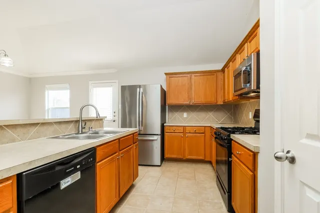 a kitchen with granite countertop a stove and a sink