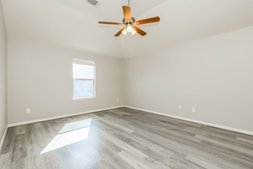 11747 Elizabeth Court Pinehurst, TX 77362 - Photo 9 of 16 an empty room with windows and fan