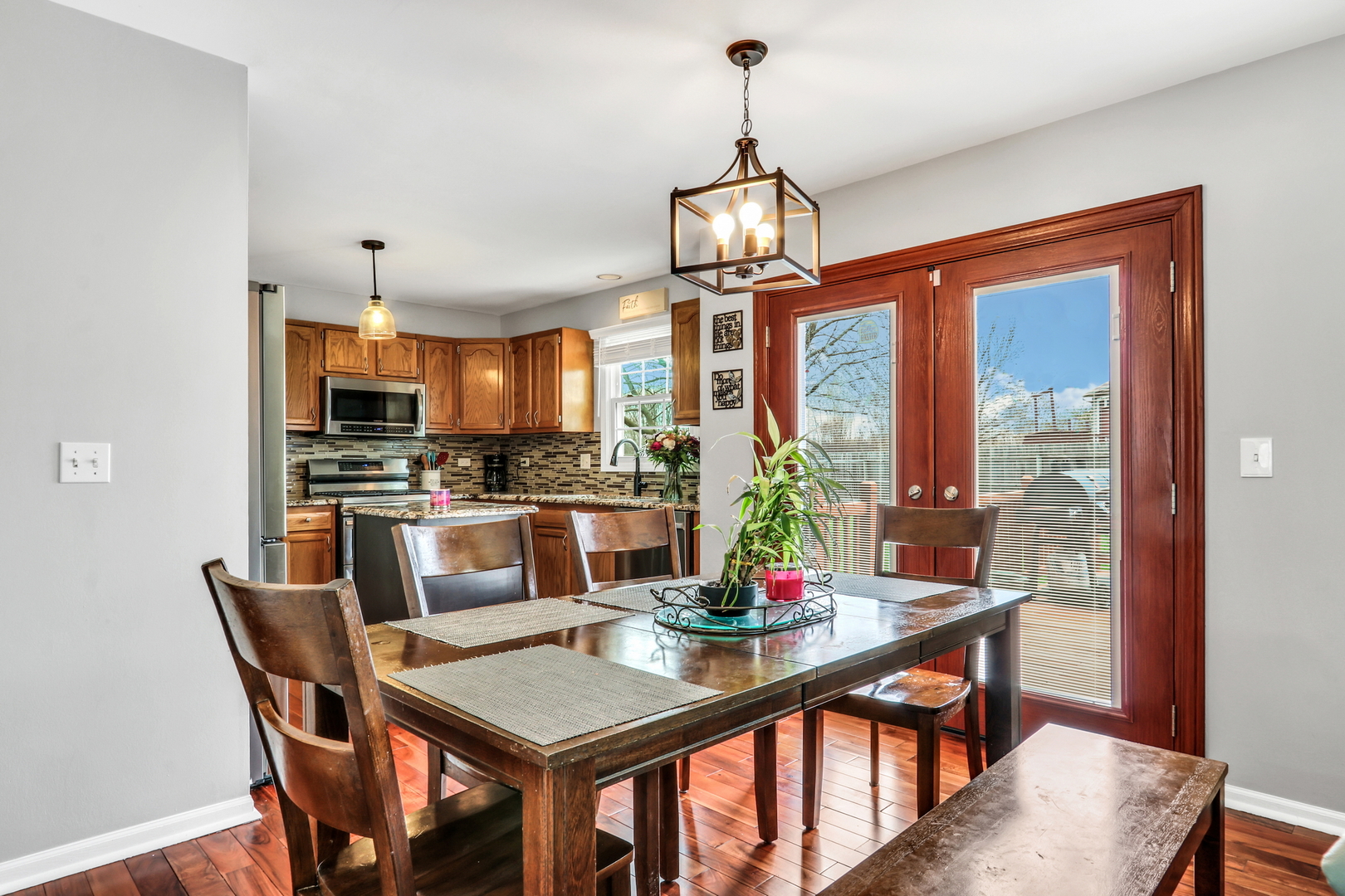 4049 Ridge Road Zion, IL 60099 - Photo 11 of 28 a view of a dining room with furniture a chandelier and wooden floor
