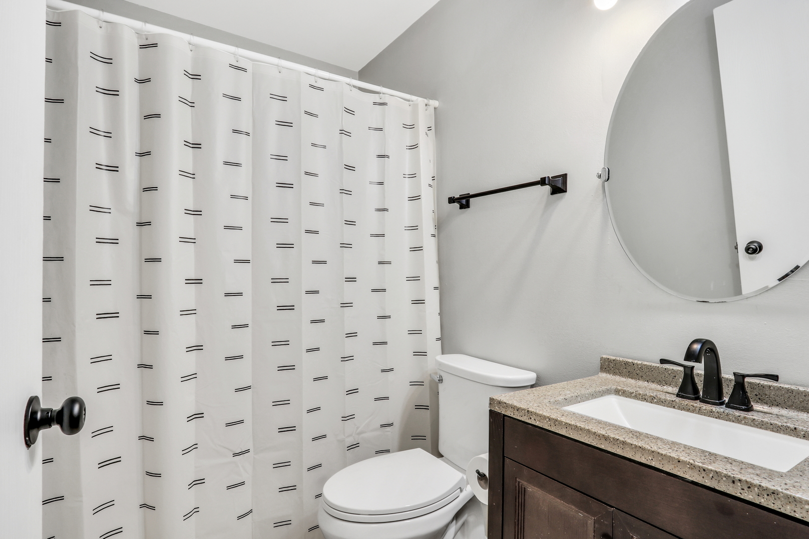 4049 Ridge Road Zion, IL 60099 - Photo 19 of 28 a bathroom with a granite countertop sink toilet a mirror and shower curtain
