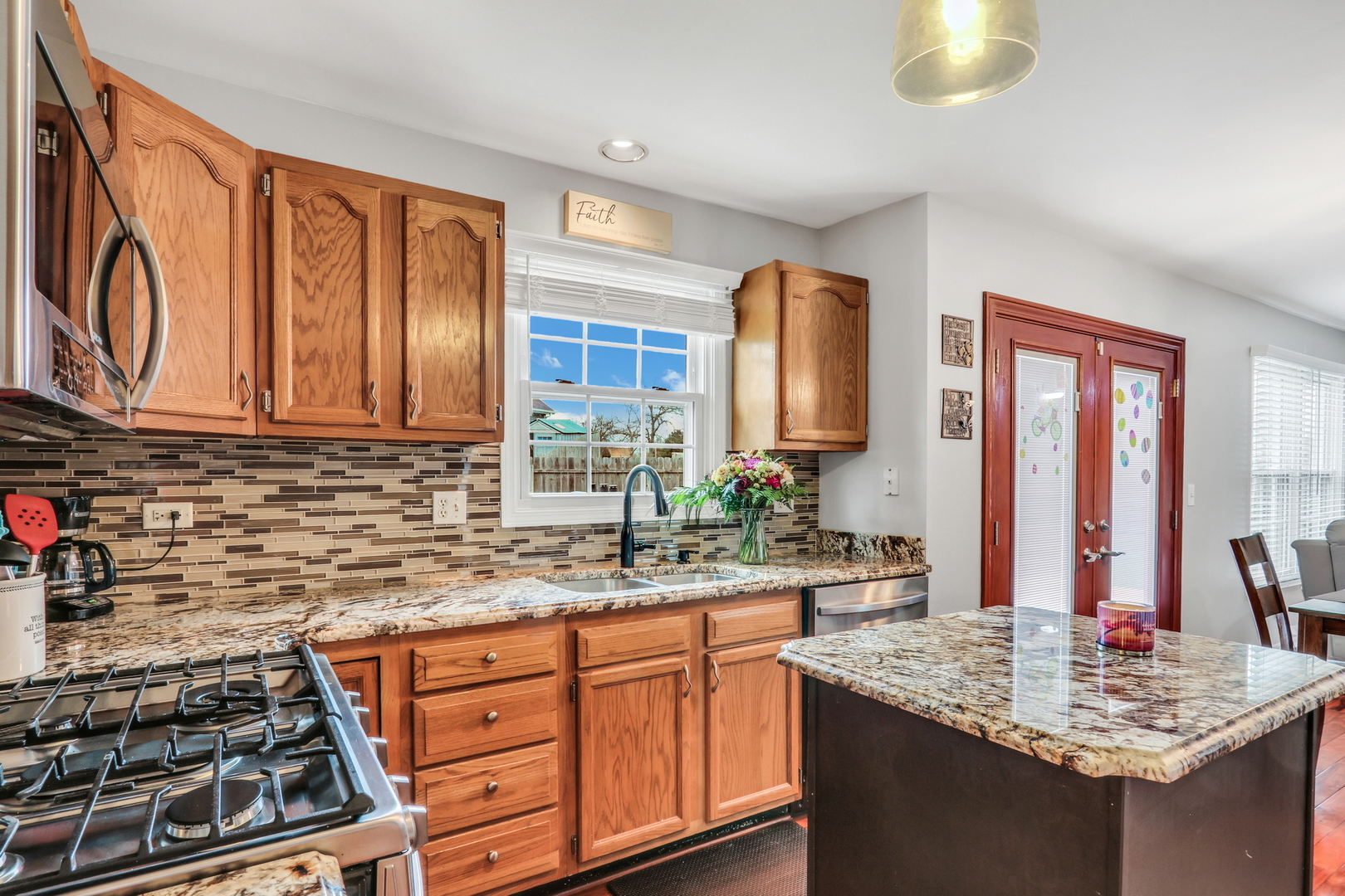 4049 Ridge Road Zion, IL 60099 - Photo 6 of 28 a kitchen with stainless steel appliances granite countertop a sink stove and cabinets