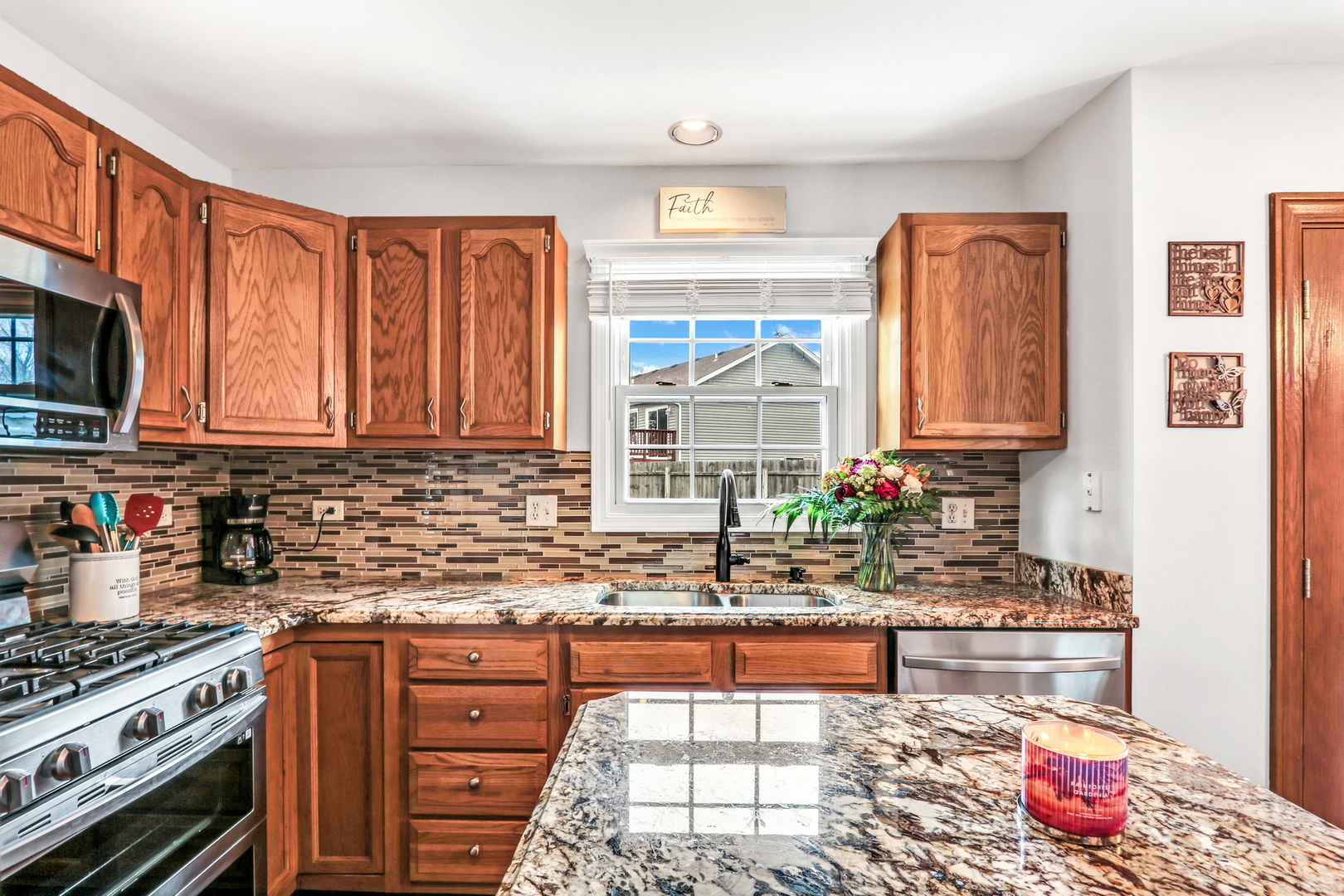 4049 Ridge Road Zion, IL 60099 - Photo 7 of 28 a kitchen with stainless steel appliances granite countertop a stove a sink and a microwave