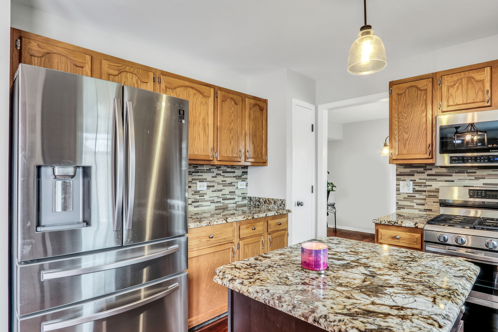 4049 Ridge Road Zion, IL 60099 - Photo 9 of 28 a kitchen with stainless steel appliances granite countertop a refrigerator and stove