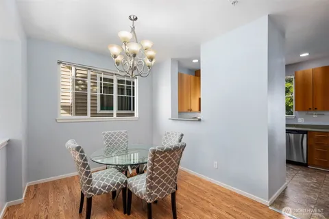 a view of a dining room with furniture and chandelier