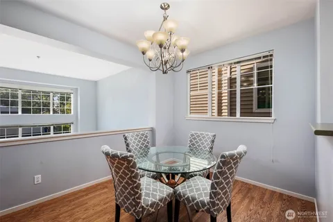 a view of a dining room with furniture and chandelier