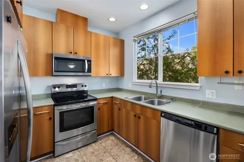 a kitchen with a sink stove and microwave